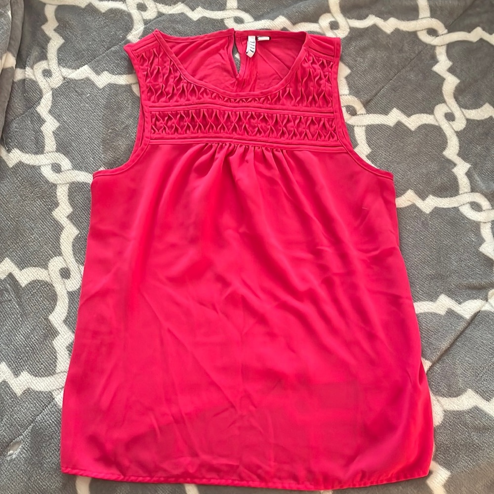 Fuscia sleeveless tank with detailed top.